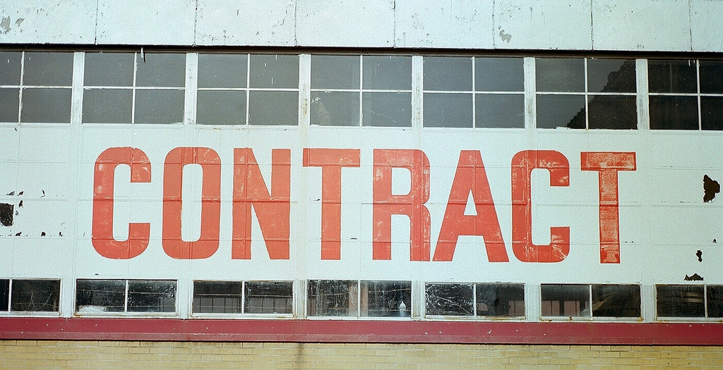 Building with the word 'contract' written on it in large red capital letters