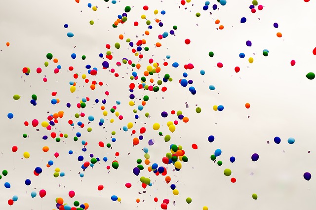 many multicolored balloons on a white background