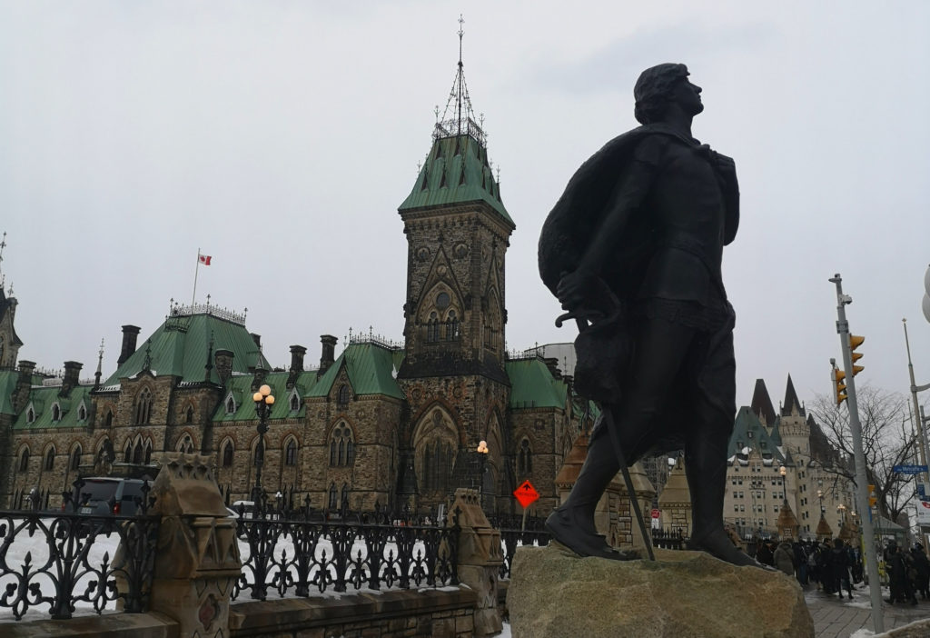 The statue of Galahad in front of Parliament Hill with parliament block building in background