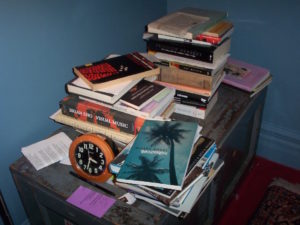 a heap of books by a bedside