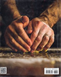 Hands kneading dough - back cover of The Tucci Table : cooking with family and friends