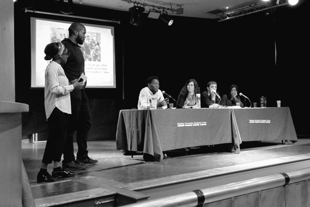 Photo of two students and four staff (including Nicola Abram) onstage.
