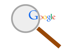 Magnifying glass examining Google logo
