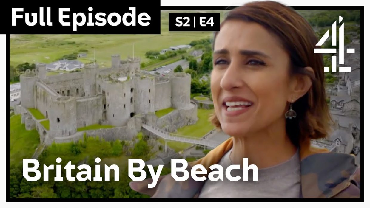 Anita Rani in near profile with Harlech Castle in the background.
