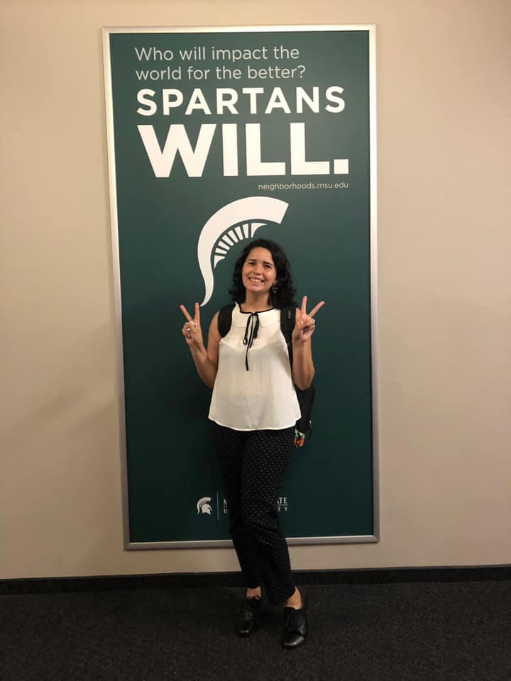 picture of my, Gabriela M, posing with the "Spartans Will" sign at MSU