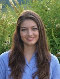 Portrait of the author with green plants in the background