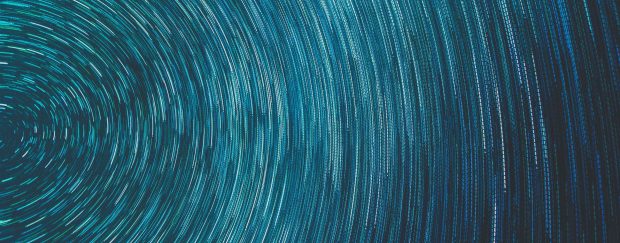 long exposure of stars, teal on dark blue-black, abstract rotation