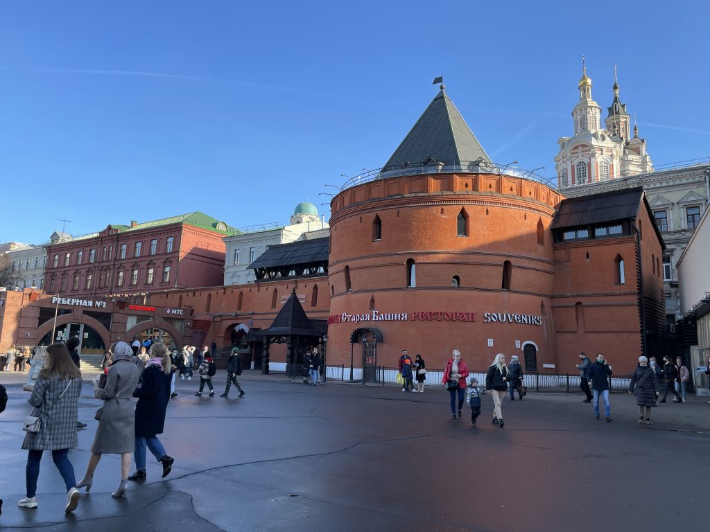 The medieval red brick wall viewed from a greater distance. The round tower at the corner now houses a restaurant. 