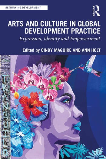 colorful image of the book cover Arts and Culture in Global Development Practice: Expression, Identity, and Empowerment
It has the profile of a girls face painted with purple skin tones. She is wearing a crown of flowers and a hummingbird is at the top of her crown drinking nectar from one of the flowers.