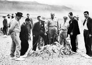 Military and civilian personnel inspect the Trinity site a few weeks after the test. Courtesy of the United States Army Signal Corps