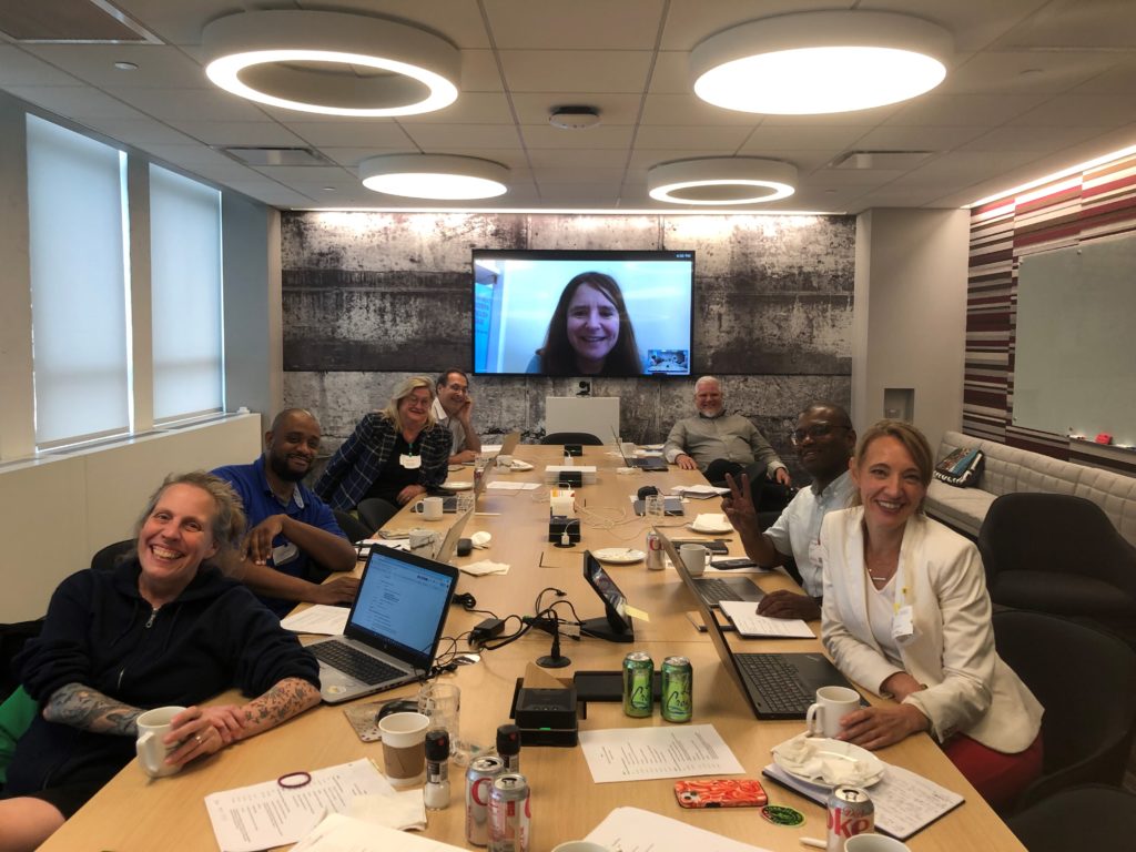 Task force members at a table in a conference room. 