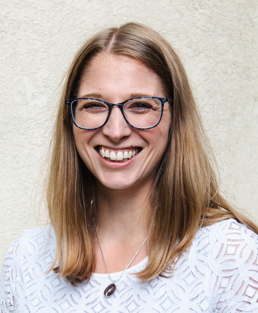 A picture of me in a white shirt with shoulder length hair